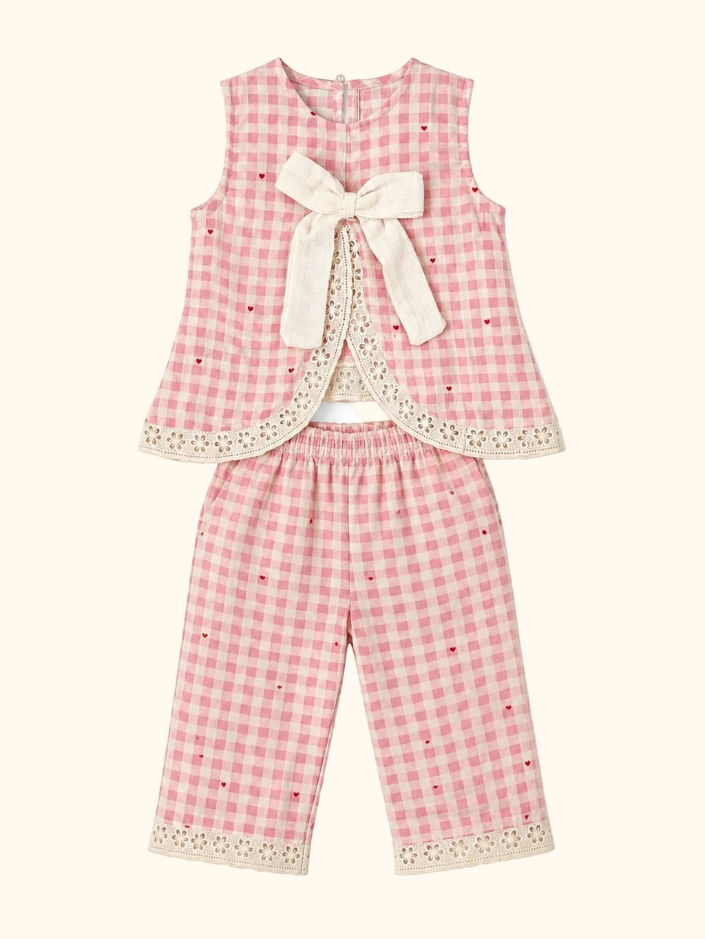 Cocolooms pink and white gingham two-piece set with ivory bow, red embroidery, and eyelet lace trim on top and trousers.