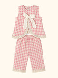Cocolooms pink and white gingham two-piece set with ivory bow, red embroidery, and eyelet lace trim on top and trousers.