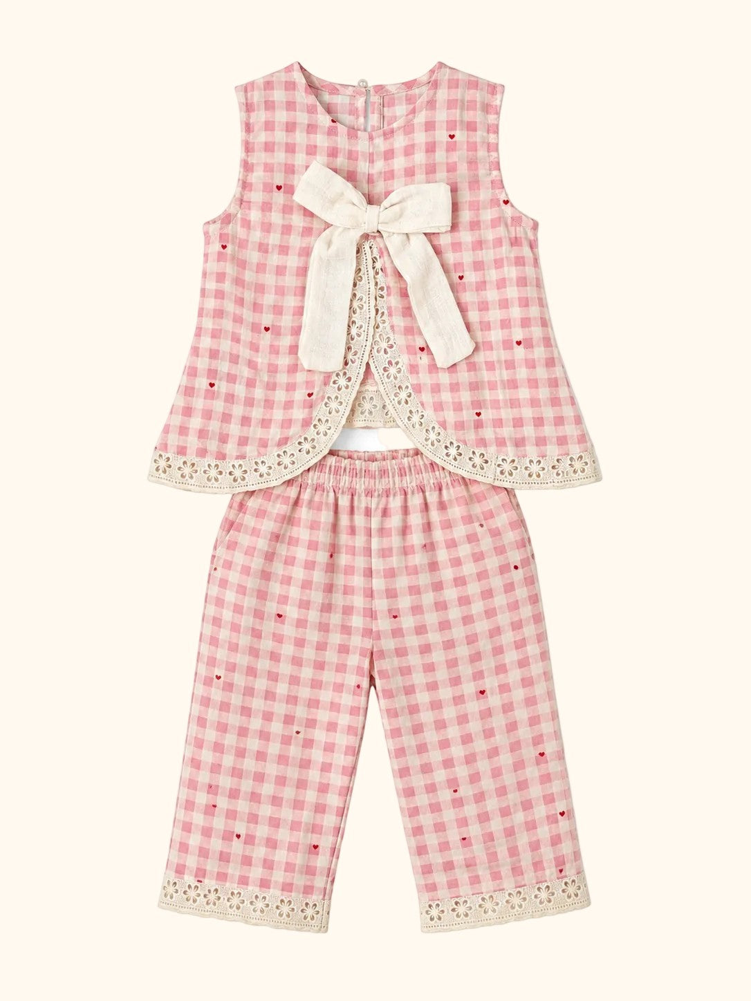 Cocolooms pink and white gingham two-piece set with ivory bow, red embroidery, and eyelet lace trim on top and trousers.