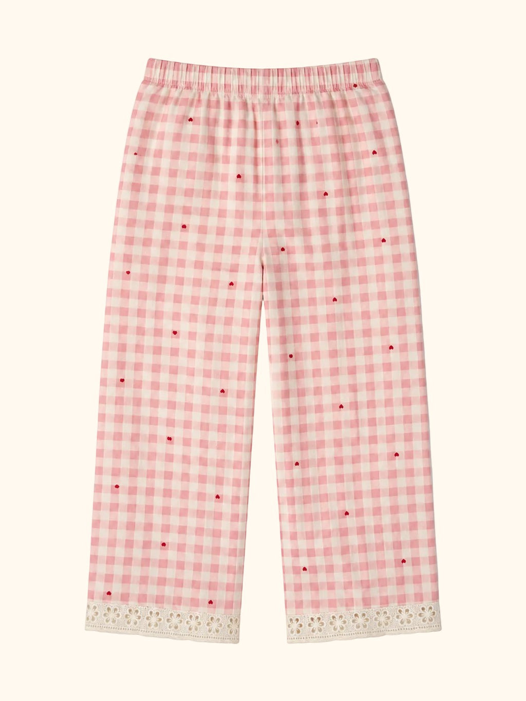 Cocolooms pink and white gingham trousers with red heart embroidery and white eyelet lace trim on the cuffs.